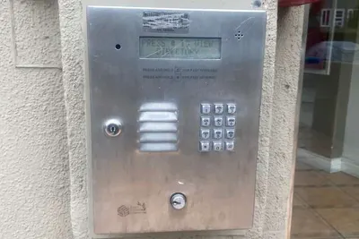 A keypad mounted at driver height beside a driveway gate