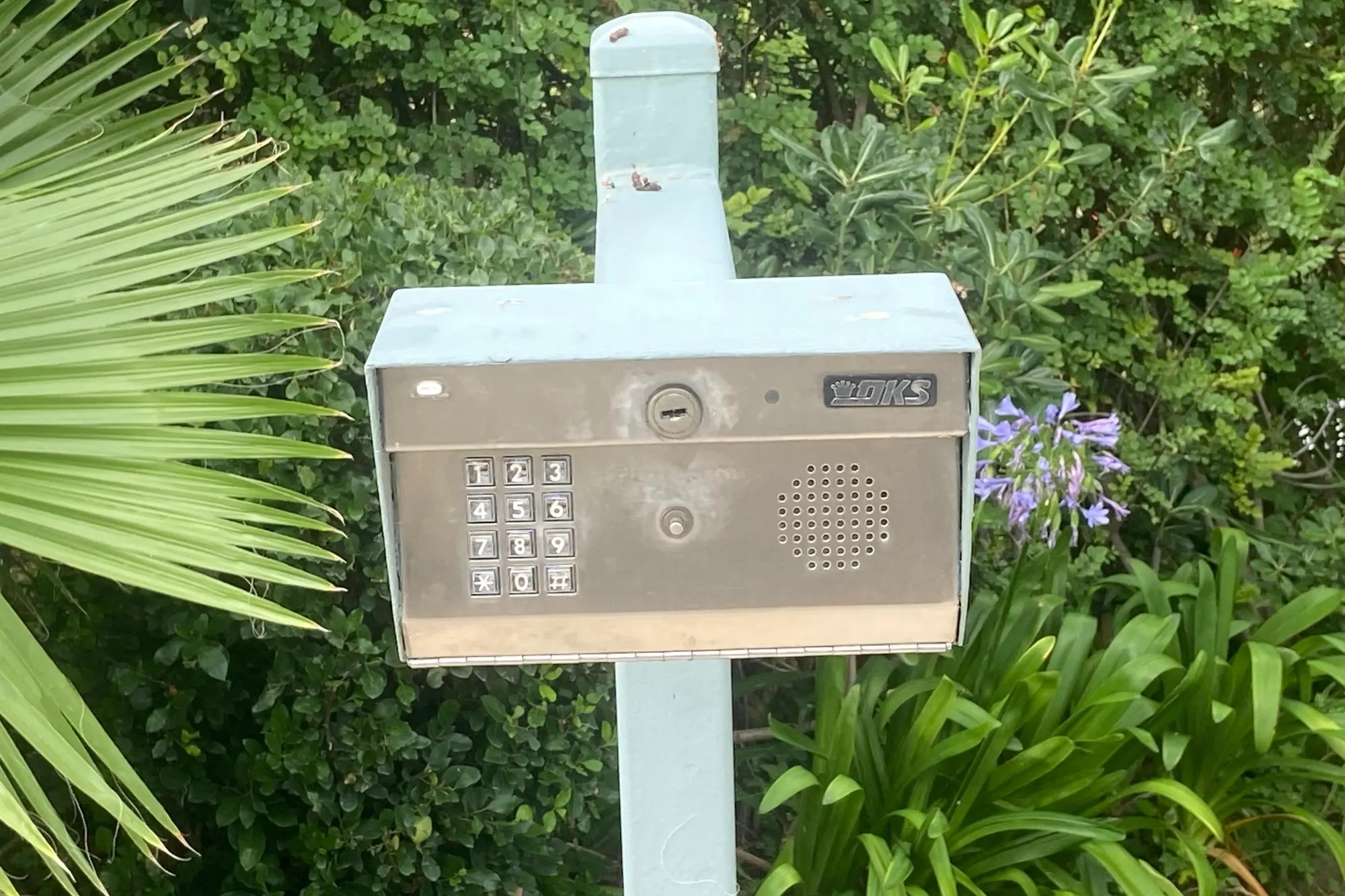 The interior of a telephone entry unit showing its circuit board and wiring