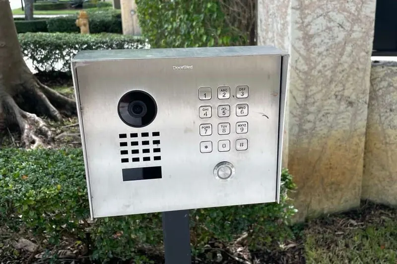 A card reader mounted on a pedestal at a controlled vehicle entrance