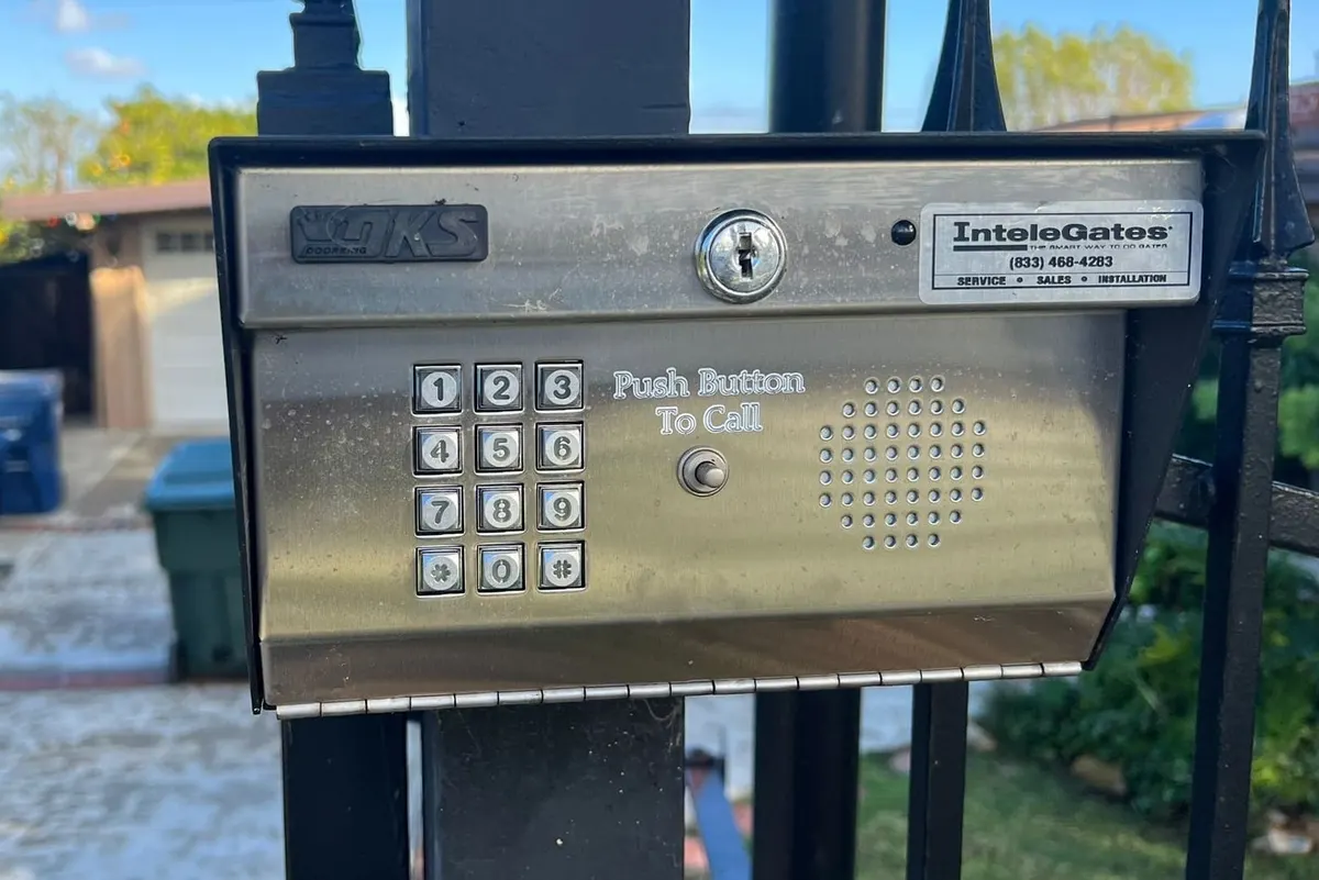 A gate access controller and power supply in a wall-mounted enclosure