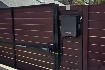 The inside of a gate operator with the control board exposed for testing