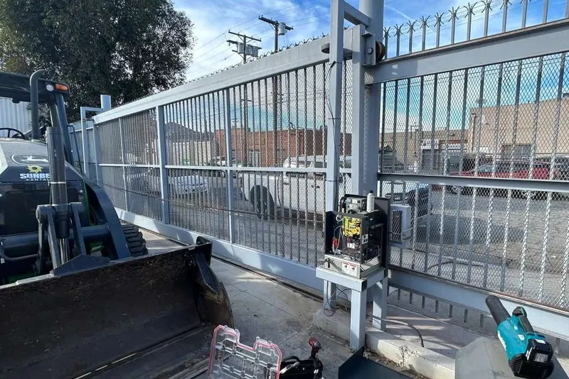 A cantilever gate at an industrial yard, partly open