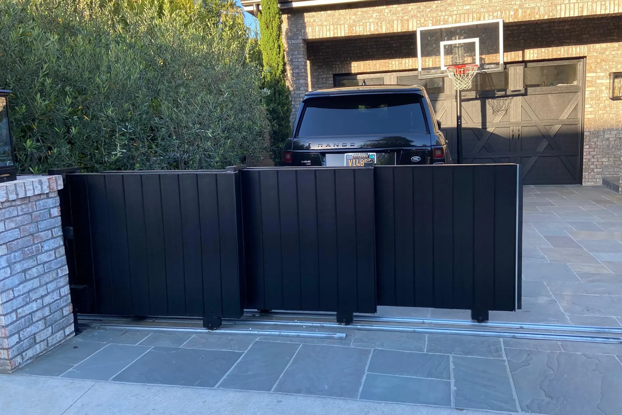 A slide gate track set into a driveway ahead of gate installation