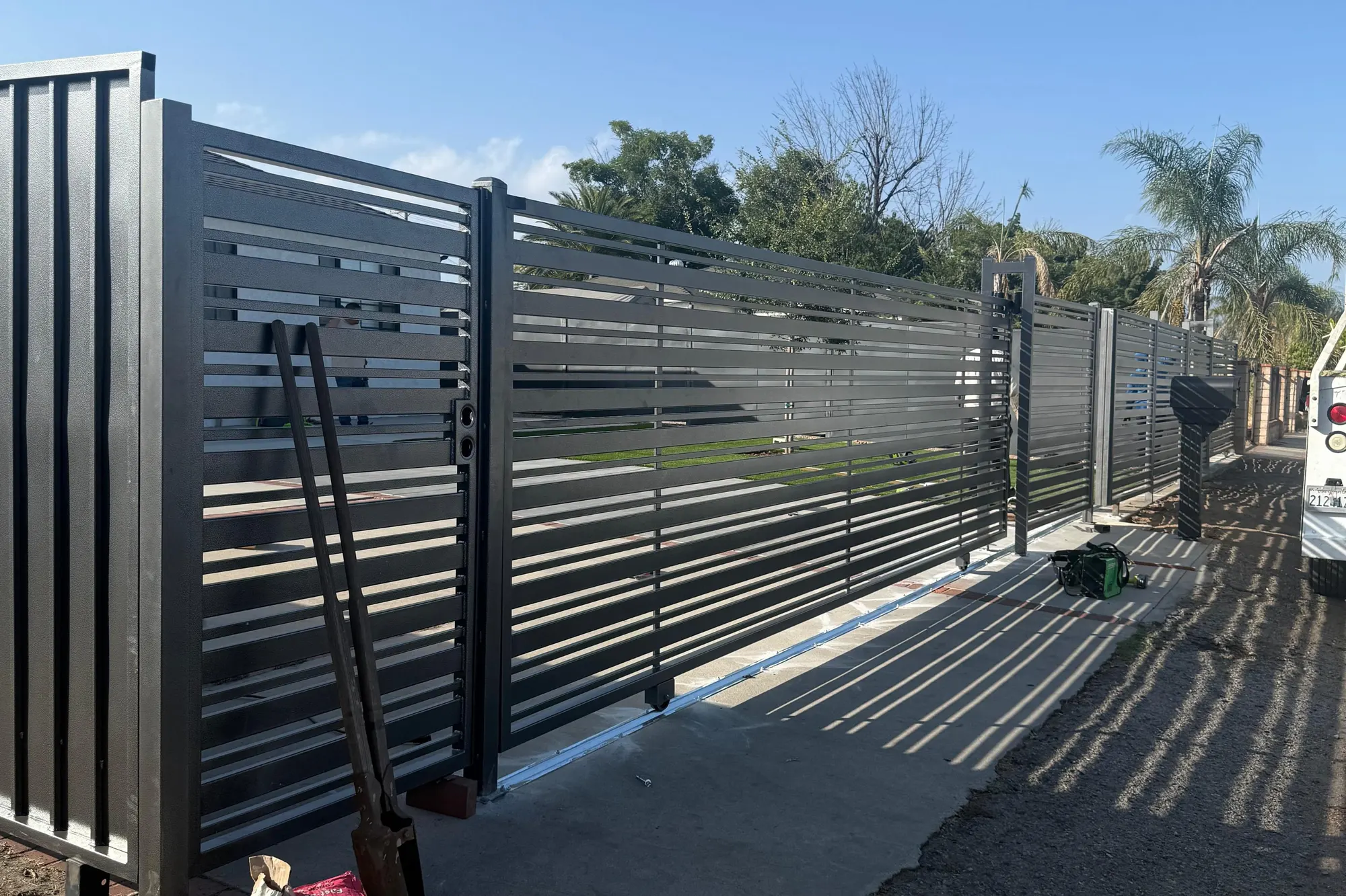 A new gate operator mounted and wired on its concrete pad