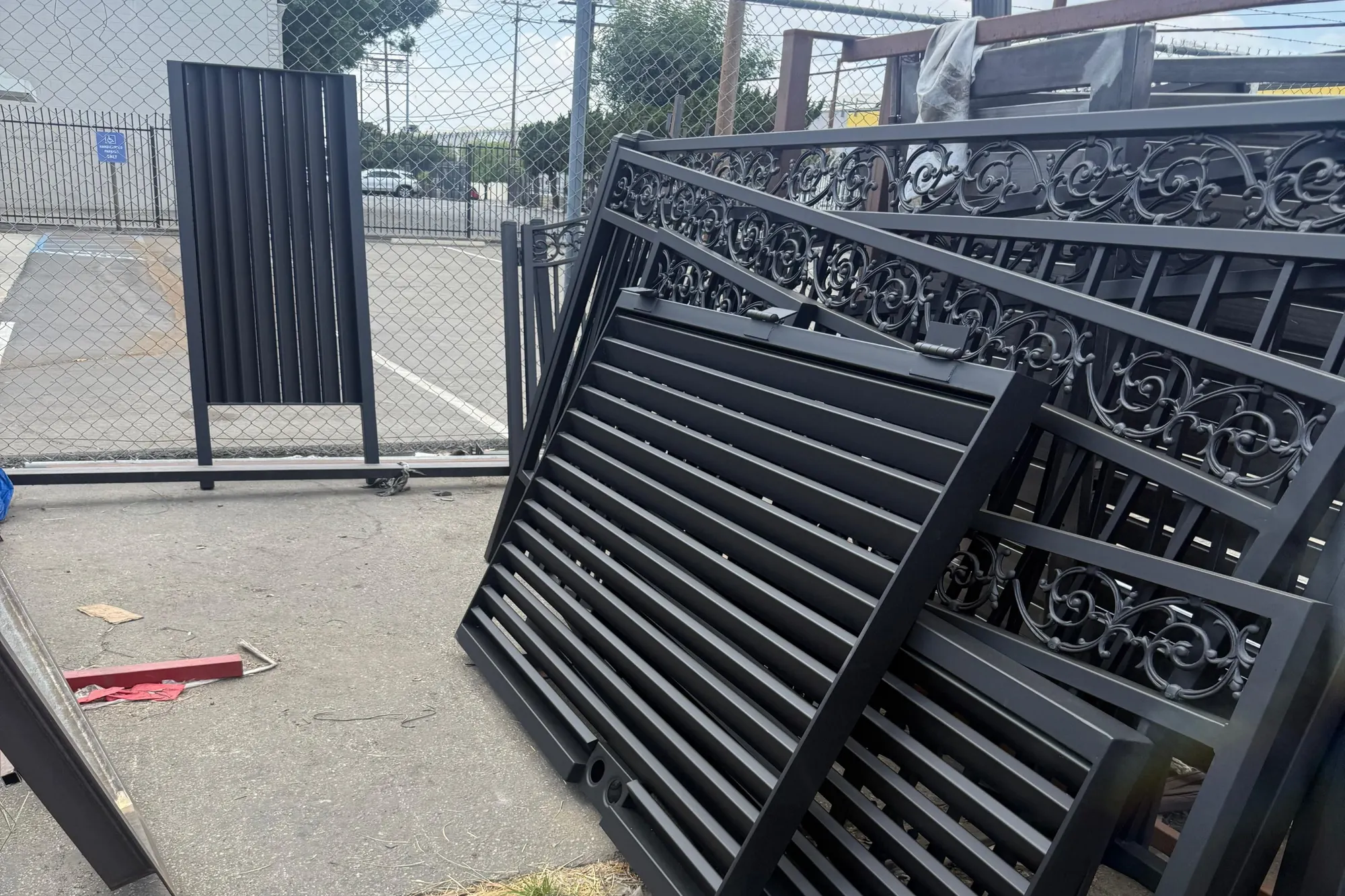 A double swing gate installed at a residential driveway, viewed from the street