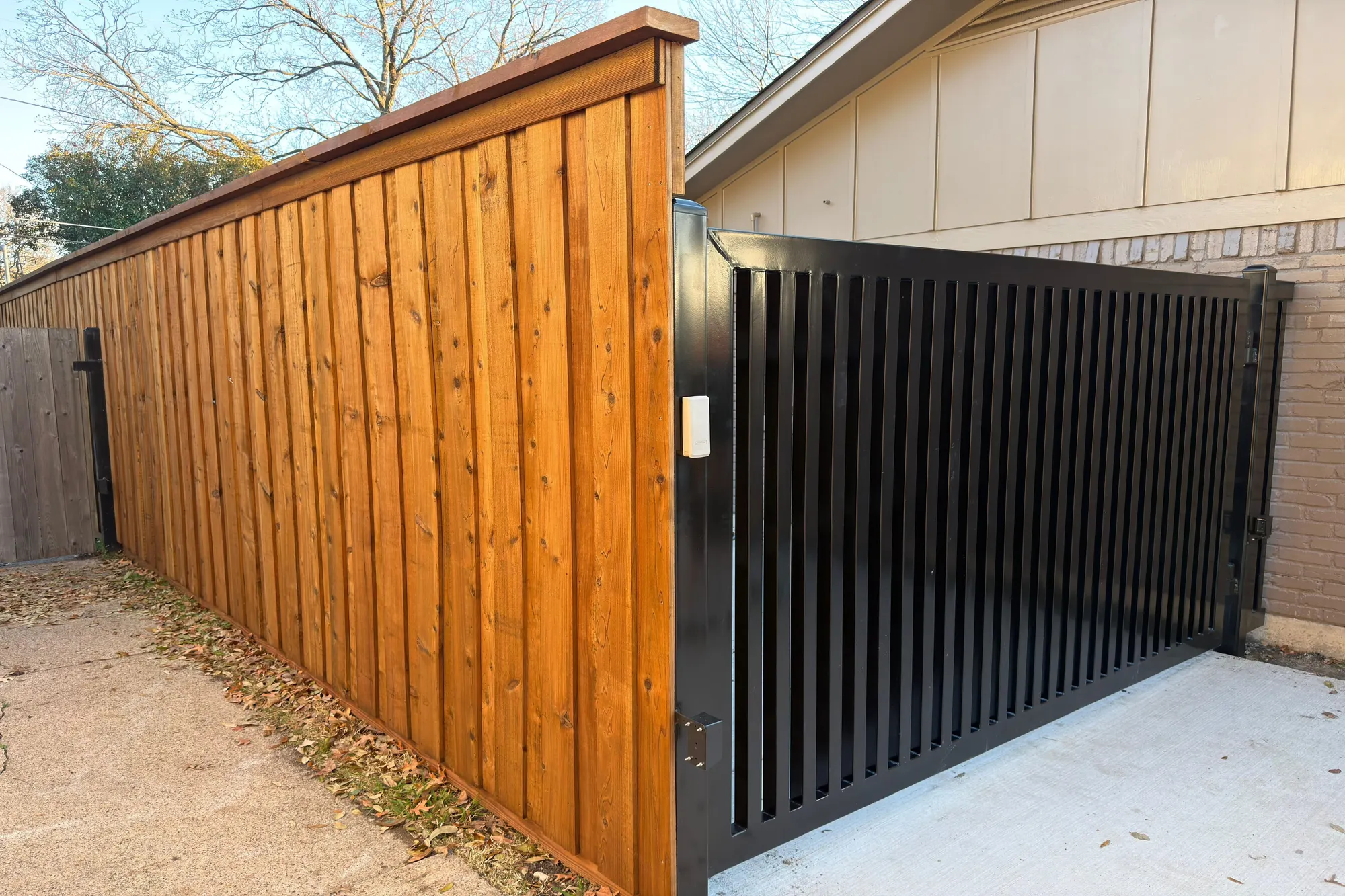 A finished automatic gate installation with the operator and control enclosure in place