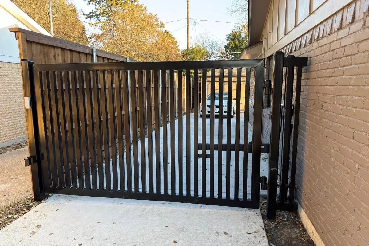A welded steel gate frame being fitted before infill panels are added