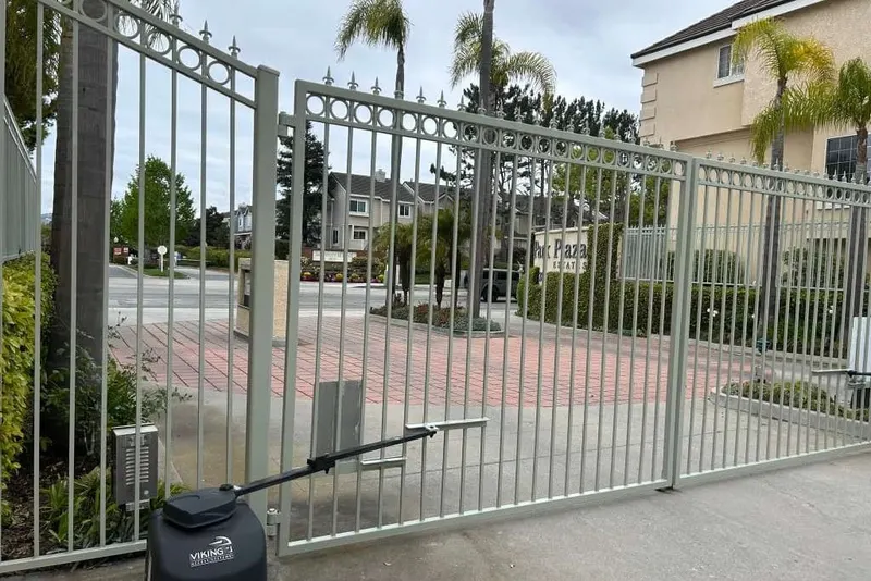 A Viking gate operator installed at a residential driveway entrance