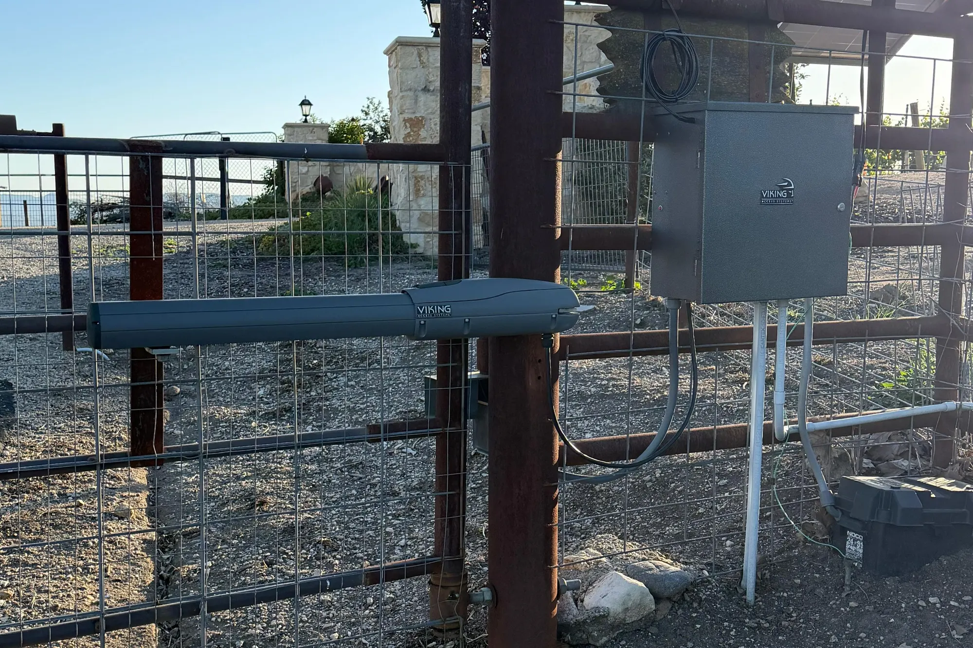 The control board and battery of a Viking DC gate operator inside its housing